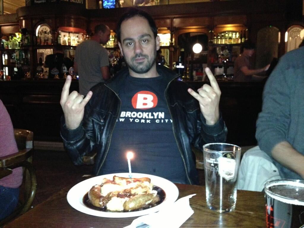 Me at the The Salisbury Hotel, celebrating my birthday in 2013 with a candle over a banger and mash